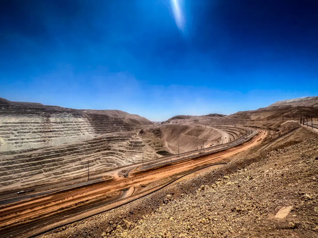 Aerial view of a large open-pit mining operation with terraced levels
