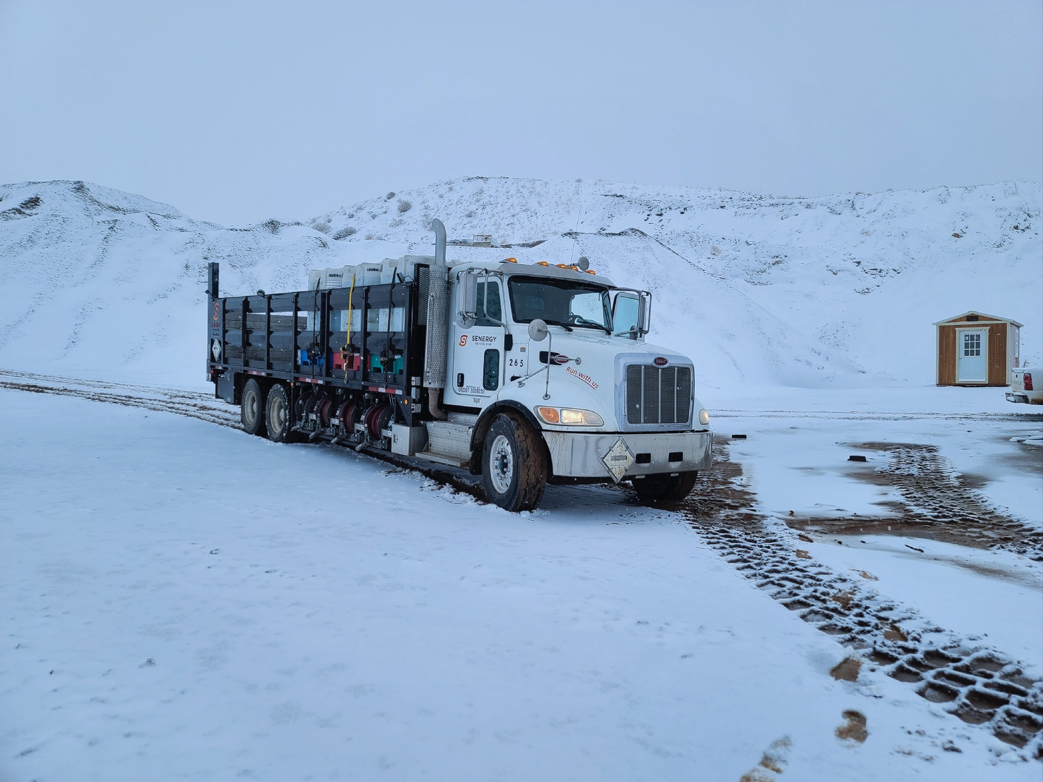 A senergy lubricants truck driving in the snow