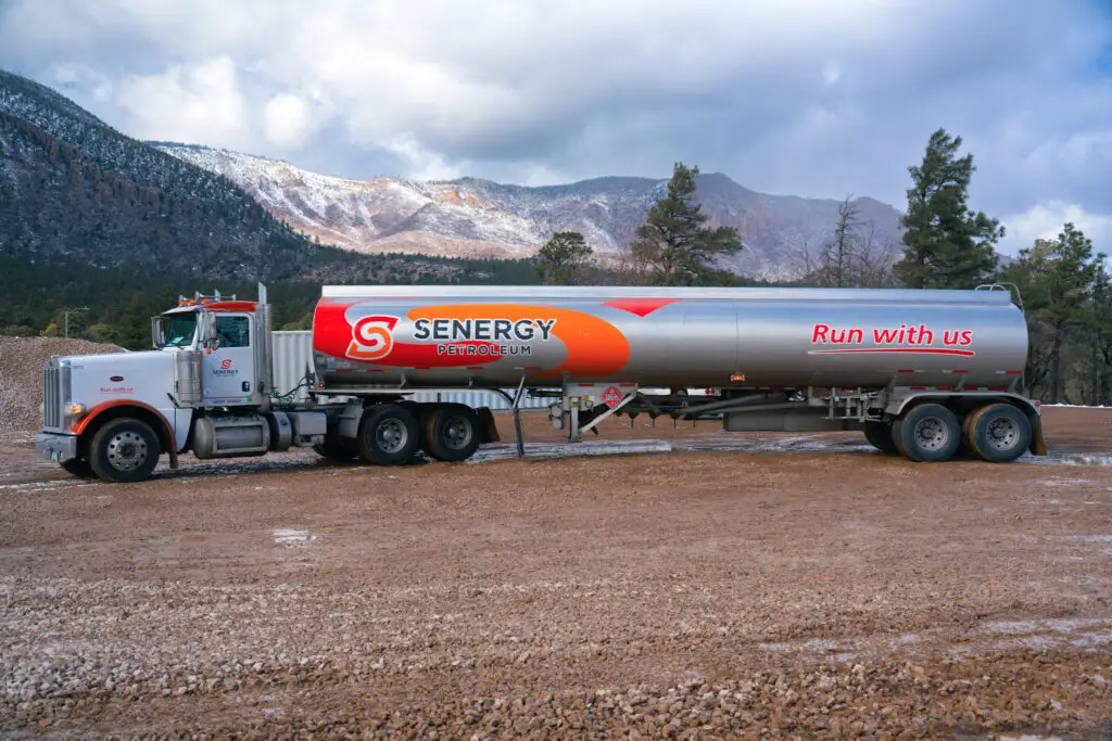 Senergy Petroleum large fuel tanker truck with snow-covered Flagstaff mountains in background